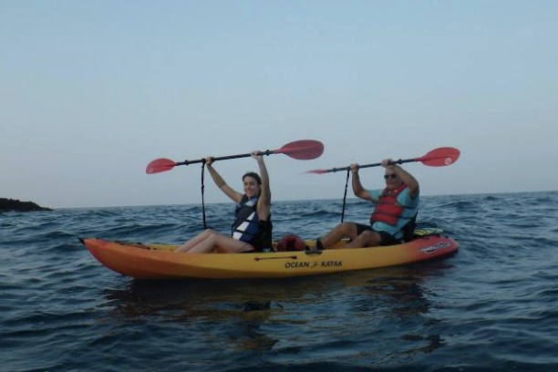 a man riding on the back of a boat in a body of water