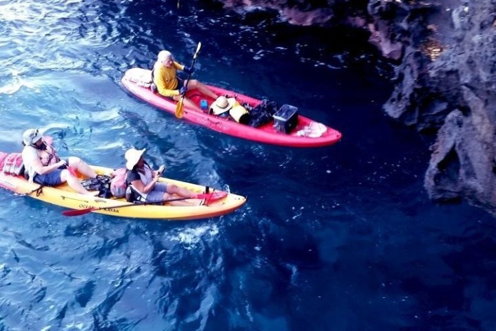 a man riding on the back of a boat in the water