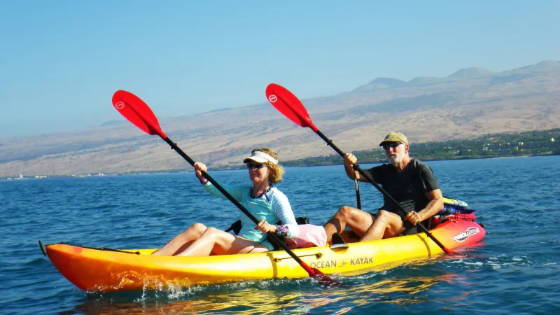 a group of people in a small boat in a body of water