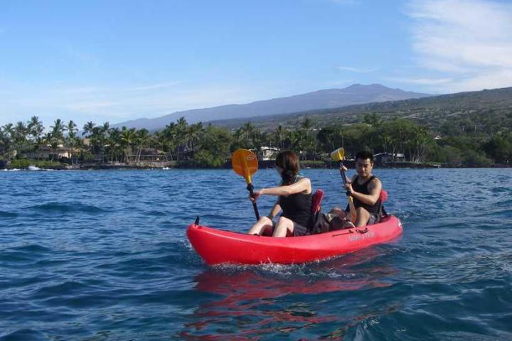 a man riding on the back of a boat in a body of water