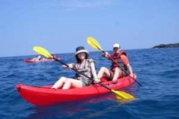 a man riding on the back of a boat in the water