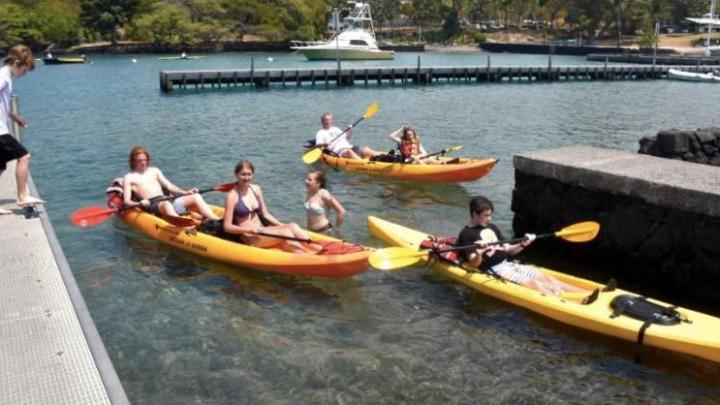 a group of people on a boat in the water